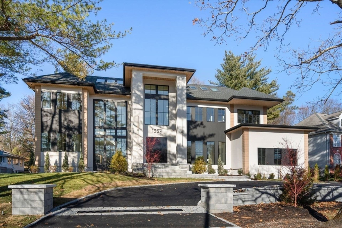 Contemporary front elevation with striking glass windows and minimalist landscaping.