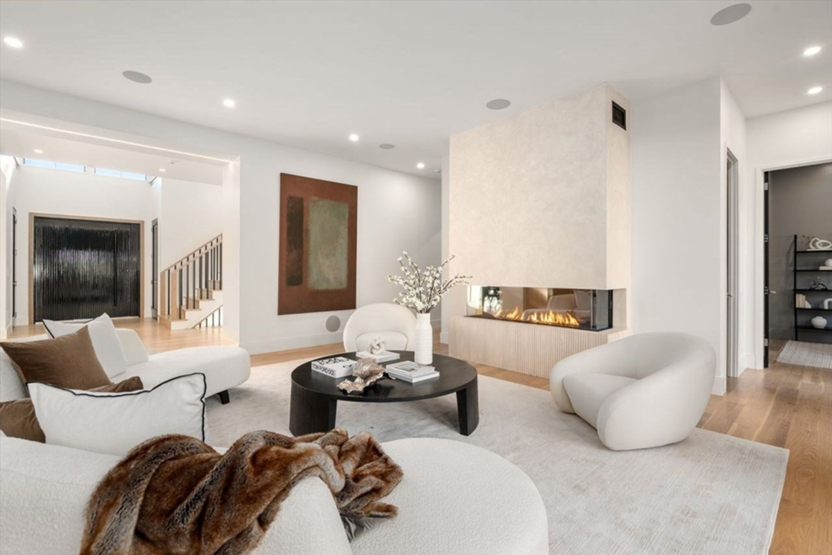 Modern living room featuring a sleek fireplace and soft neutral tones.