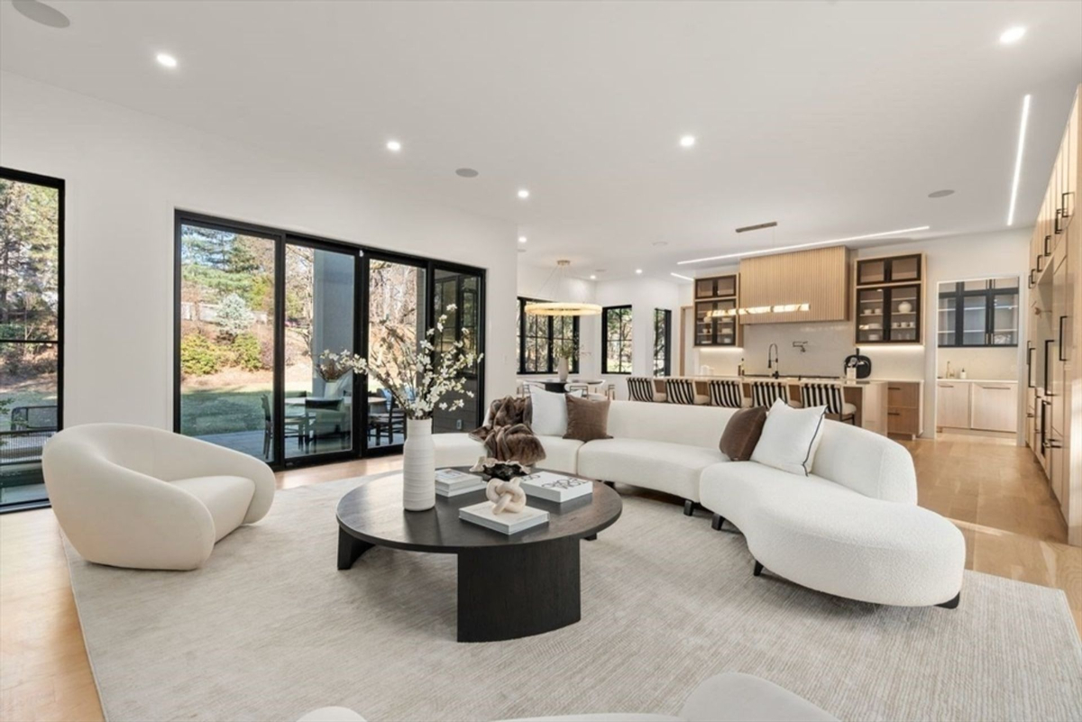 Open-concept living room with large glass doors and ample natural light