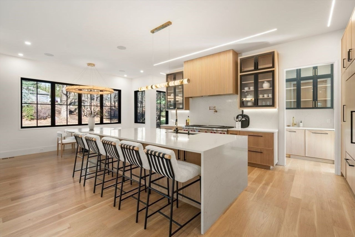 Spacious dining area adjacent to the kitchen with large windows and elegant lighting.