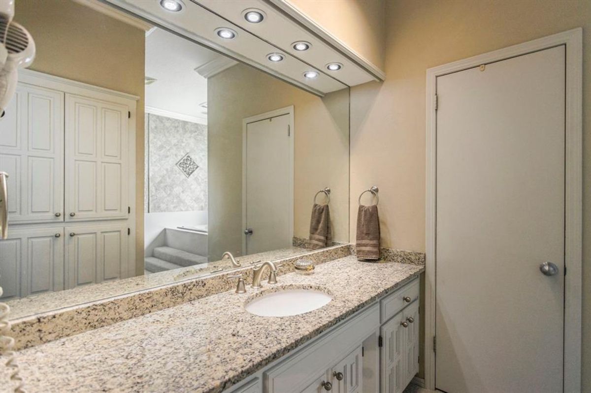 Granite countertop with a single under-mount sink and brushed nickel faucet.