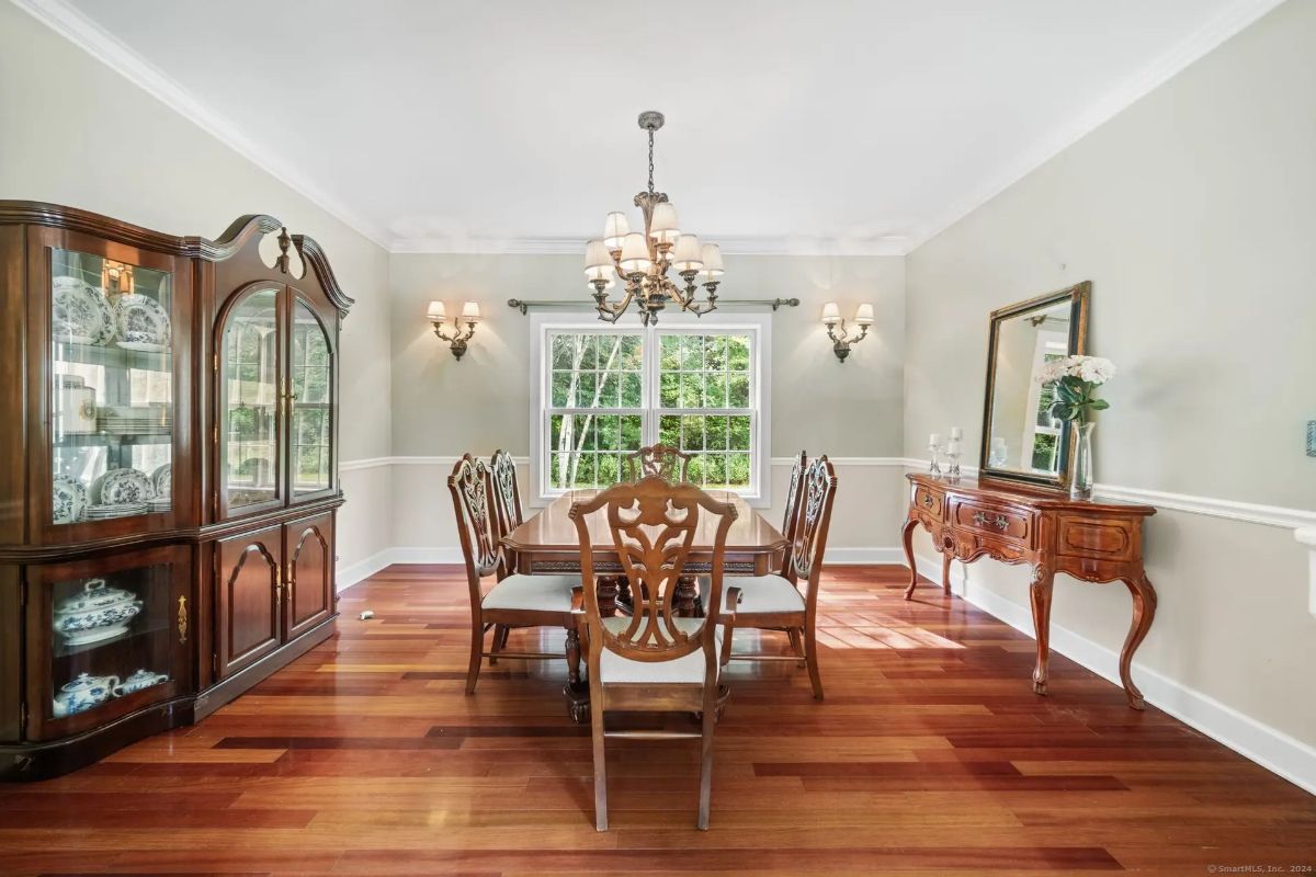 Dining area & to a kitchen with white cabinets.