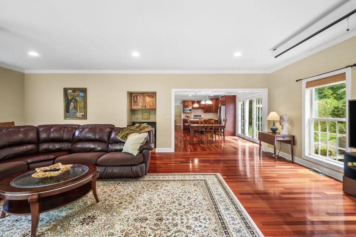 Seamless transition from the living area to the kitchen, showcasing an open floor plan with gleaming hardwood floors.