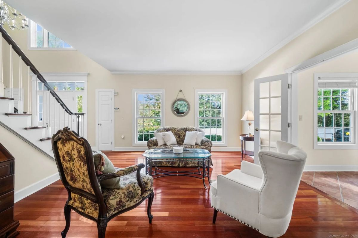 Bright living area with classic furniture, hardwood floors, and abundant natural light.