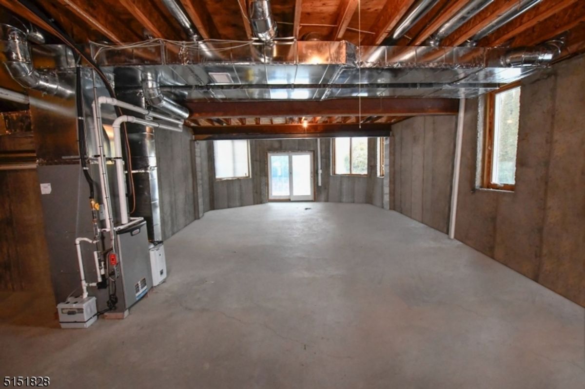 Unfinished basement with open layout and concrete flooring ready for customization.