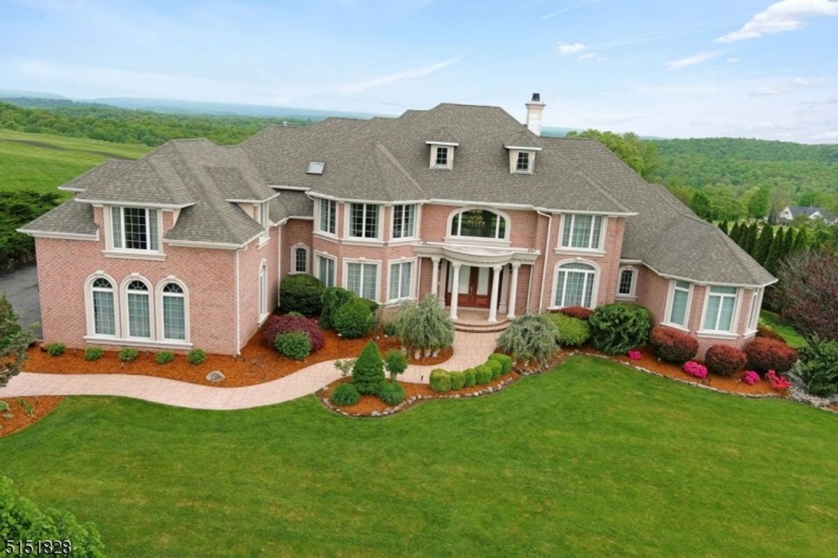 Aerial twilight view capturing expansive grounds and serene natural surroundings.