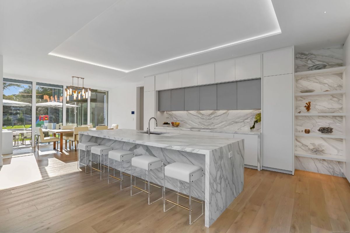 Light-filled open kitchen connects seamlessly to the dining area and outdoor space, creating an ideal setup for entertaining.