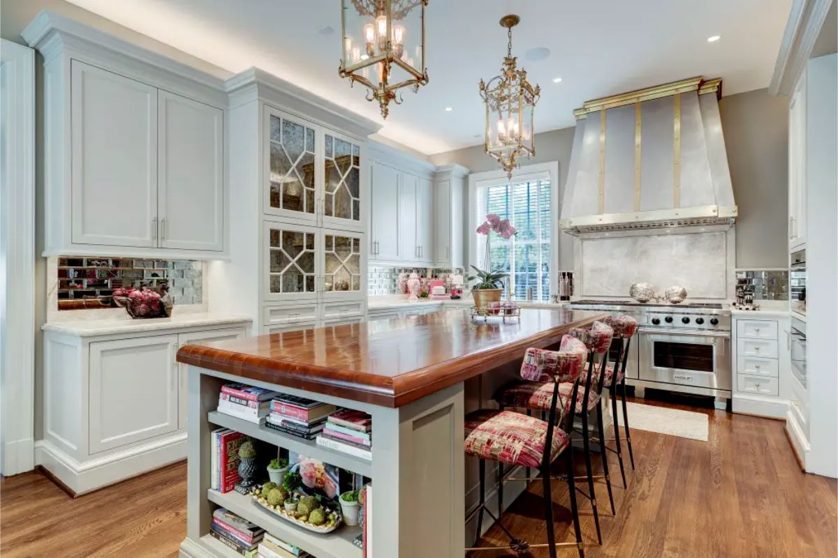 Kitchen with a polished wooden island that includes shelving and seating for four.