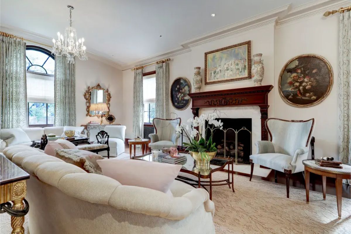 Living room centered around a carved wood fireplace with a decorative mantel.