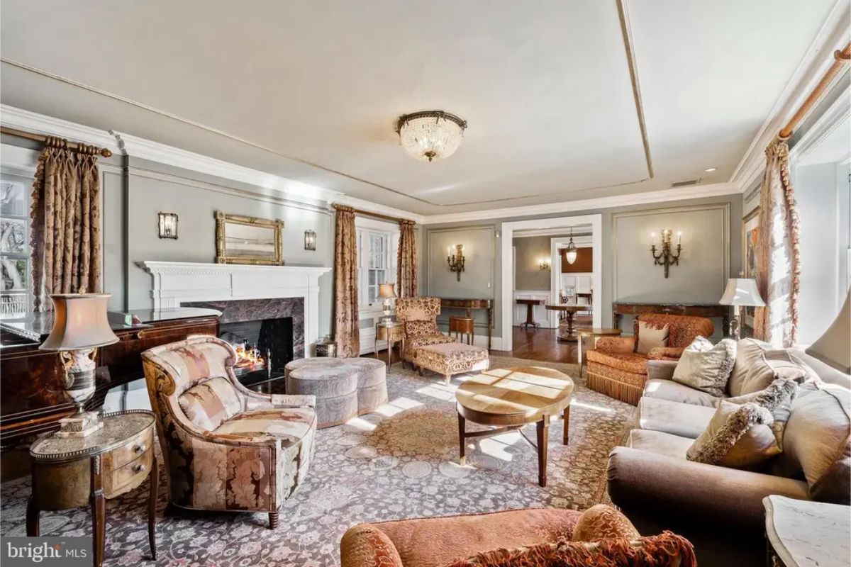 The formal living room includes a centrally positioned fireplace with an ornate mantel and marble surround.