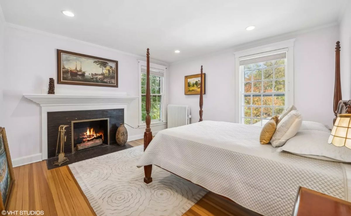 Cozy fireplace with a white mantel serves as the focal point of the room.