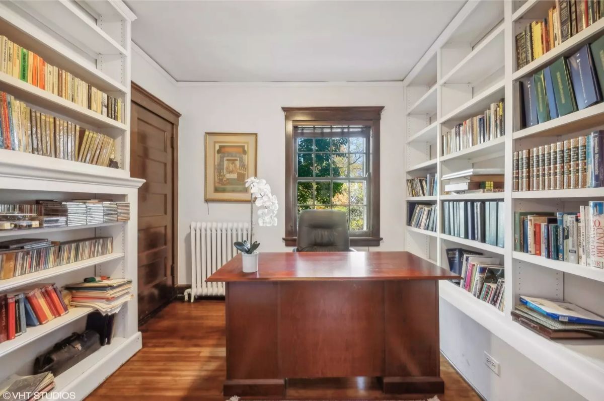 A wooden desk serves as the centerpiece of this cozy home office.