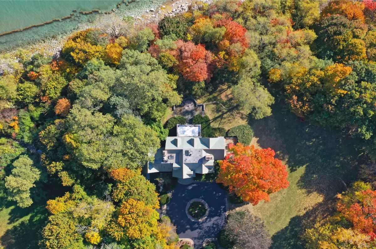 An estate nestled among vibrant autumn trees offers breathtaking seasonal views.