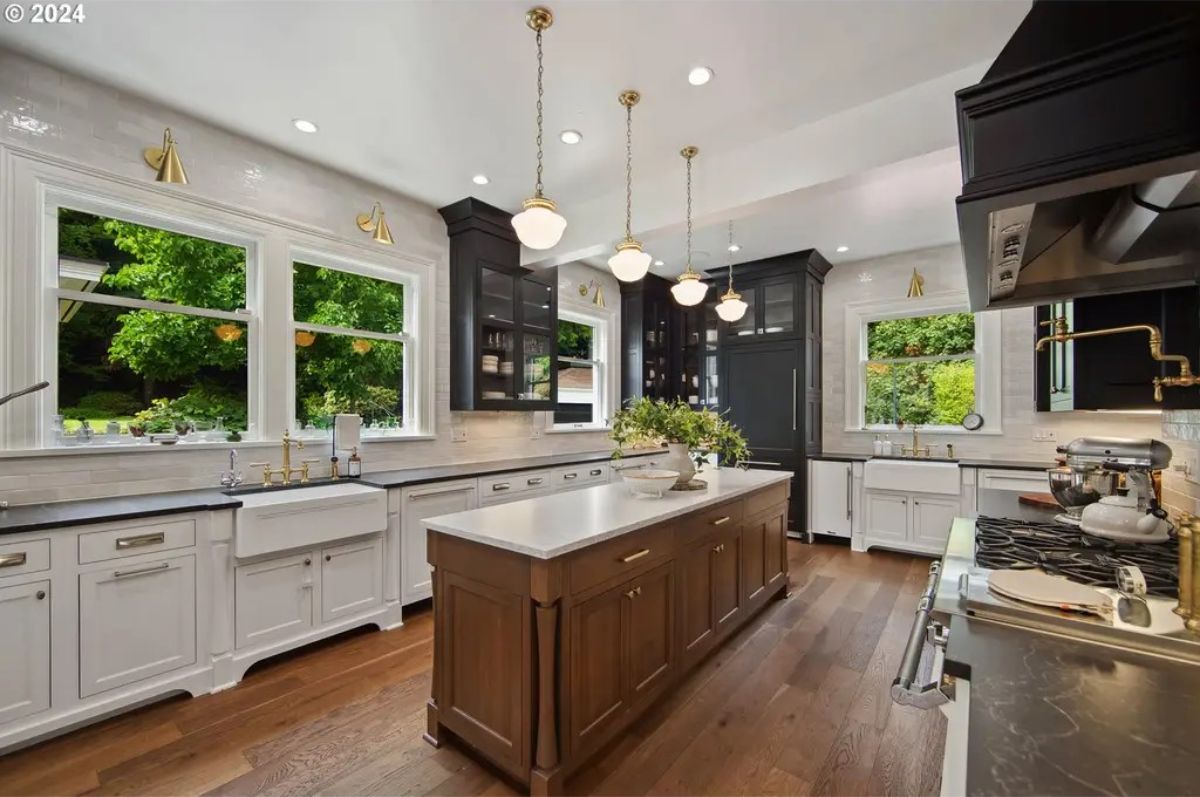 Kitchen showcases a large center island with a wood finish and marble countertop.