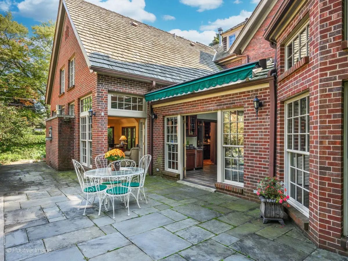 Brick and slate patio connects the home’s interior to the garden, offering an ideal space for outdoor dining.