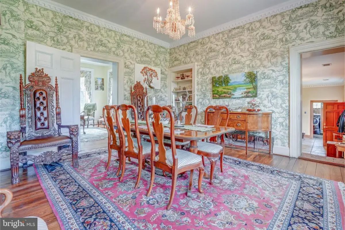 Dining room featuring a wooden table surrounded by matching chairs with striped upholstery.