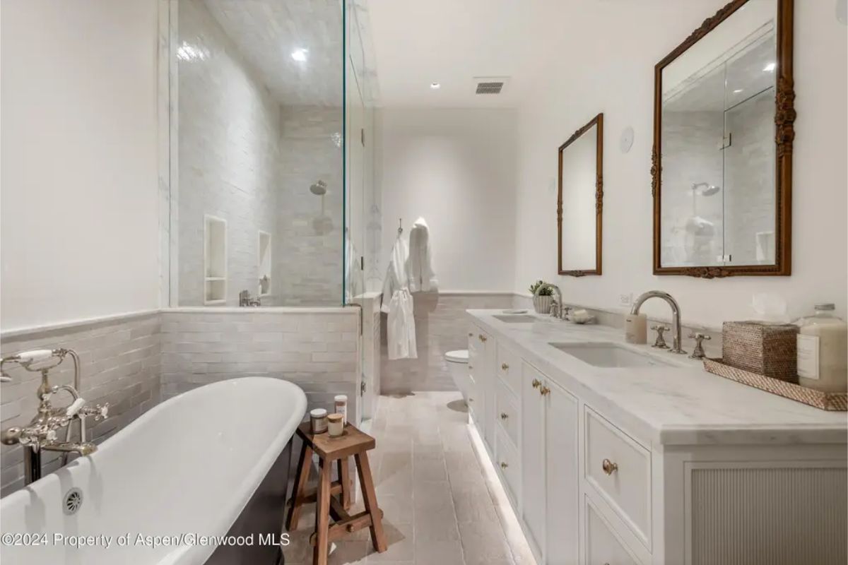 Freestanding soaking tub with vintage-inspired fixtures, offering a serene retreat for relaxation.