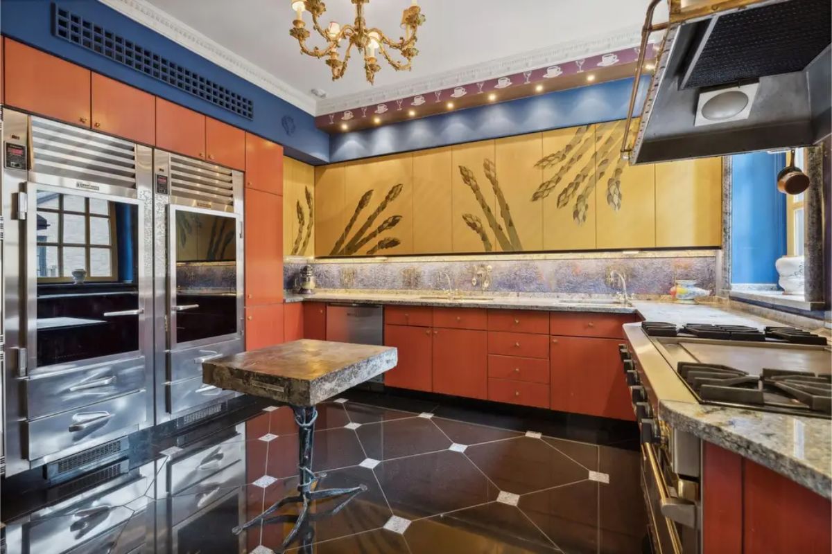 Bold kitchen design with custom gold cabinetry featuring hand-painted botanical motifs.