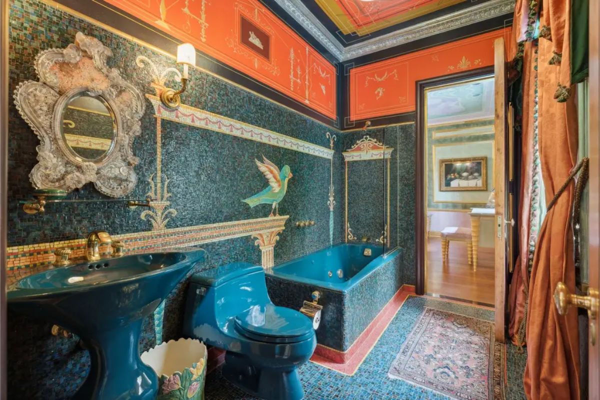 Bathroom decorated with intricate mosaic tilework featuring a bird motif and ornate patterns.