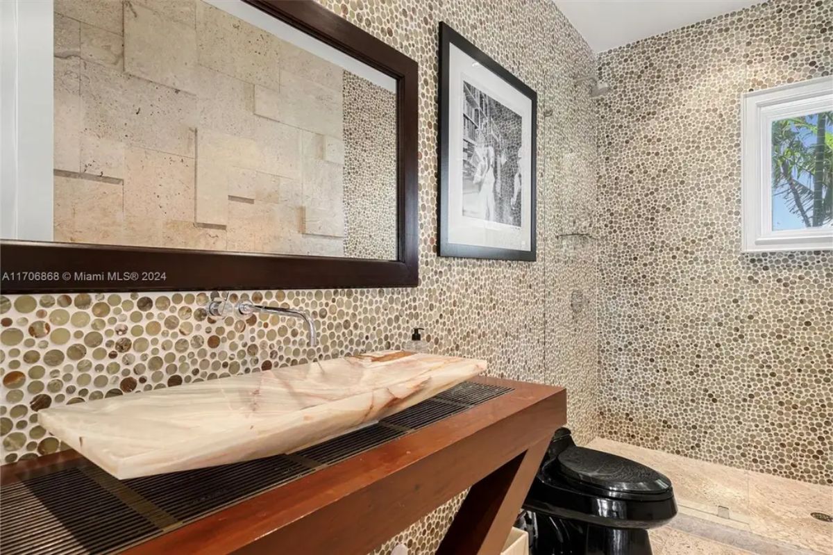 Bathroom design featuring pebble-patterned walls for a textured, organic look.