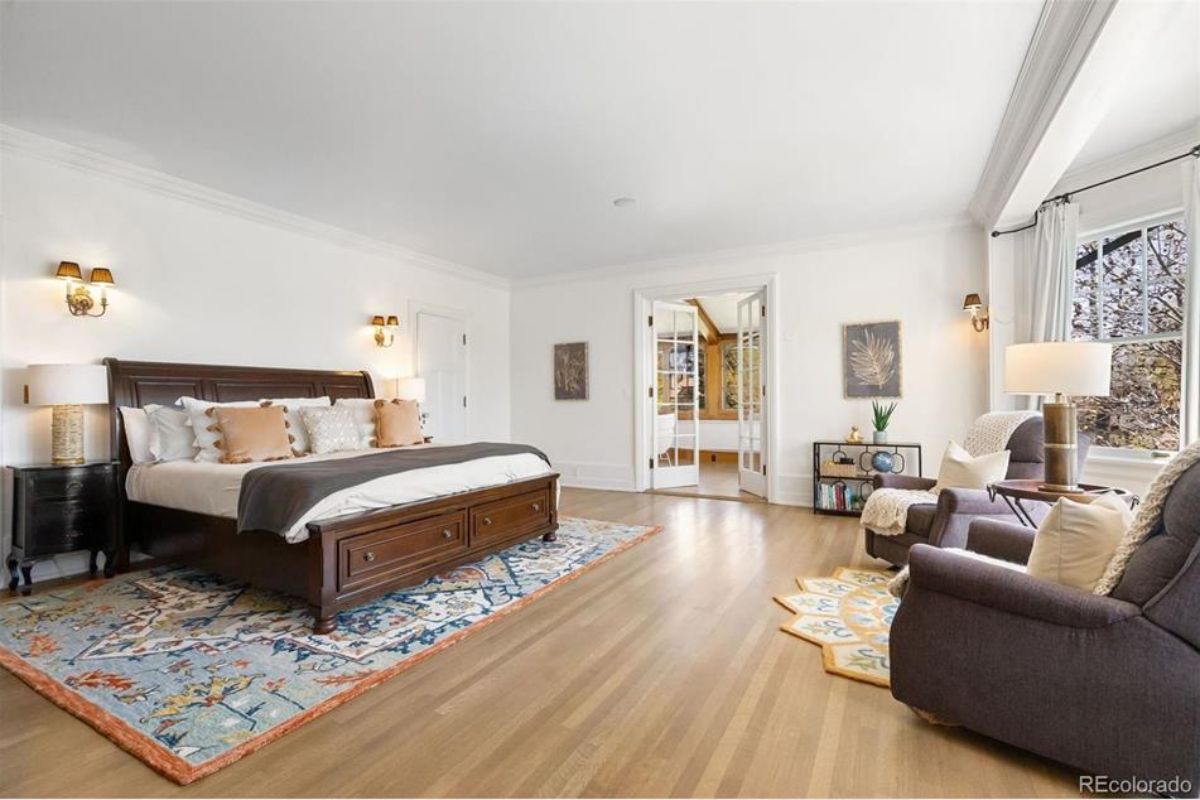 Hardwood floors and ample natural light streaming through large windows.