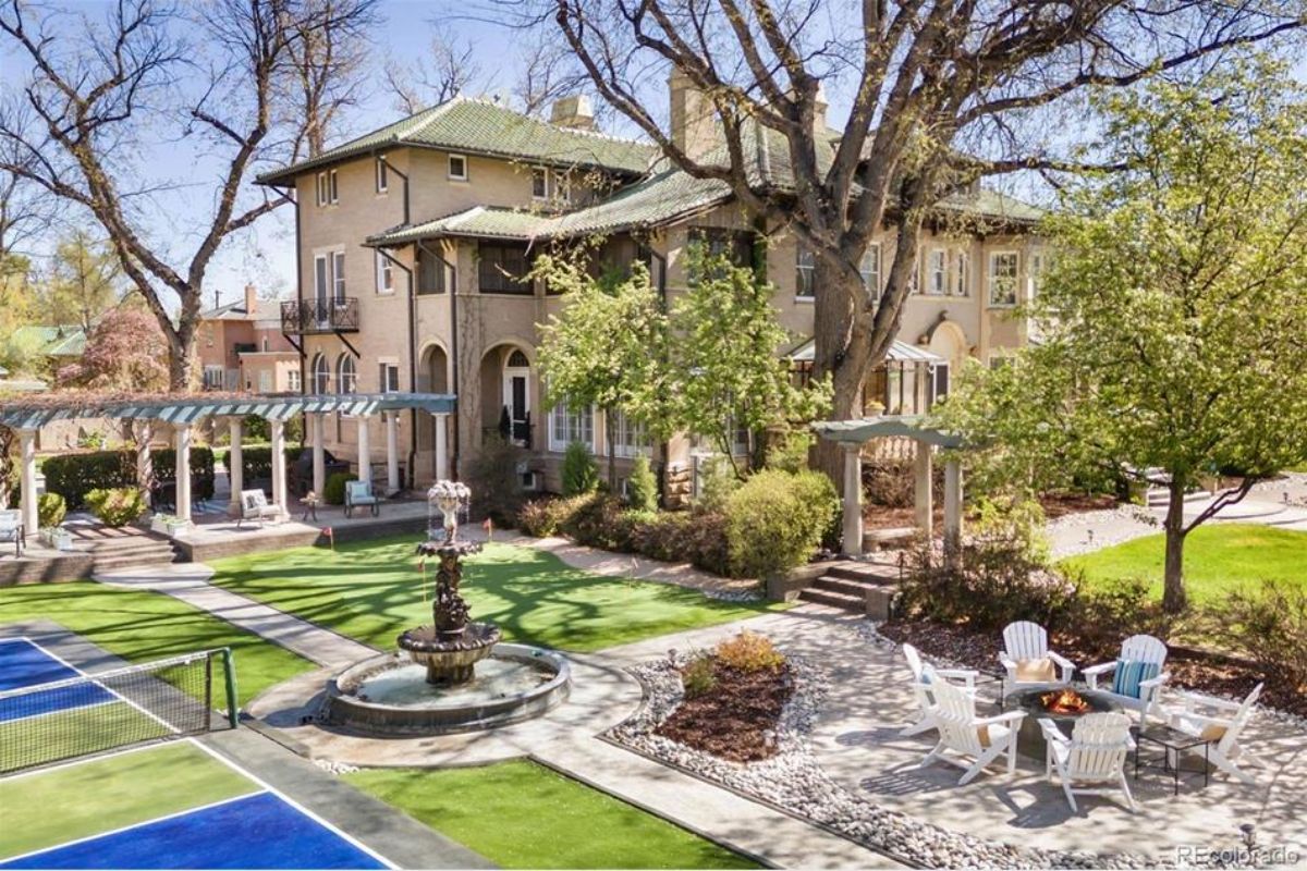 Landscaped backyard complete with a fountain, pergola, and ample seating areas for outdoor gatherings.