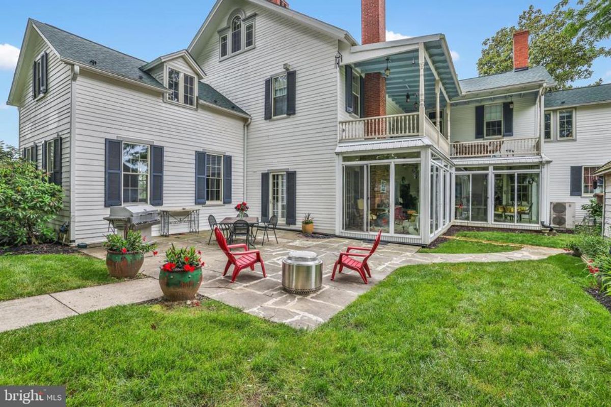 Charming backyard with a flagstone patio surrounded by a well-maintained lawn.