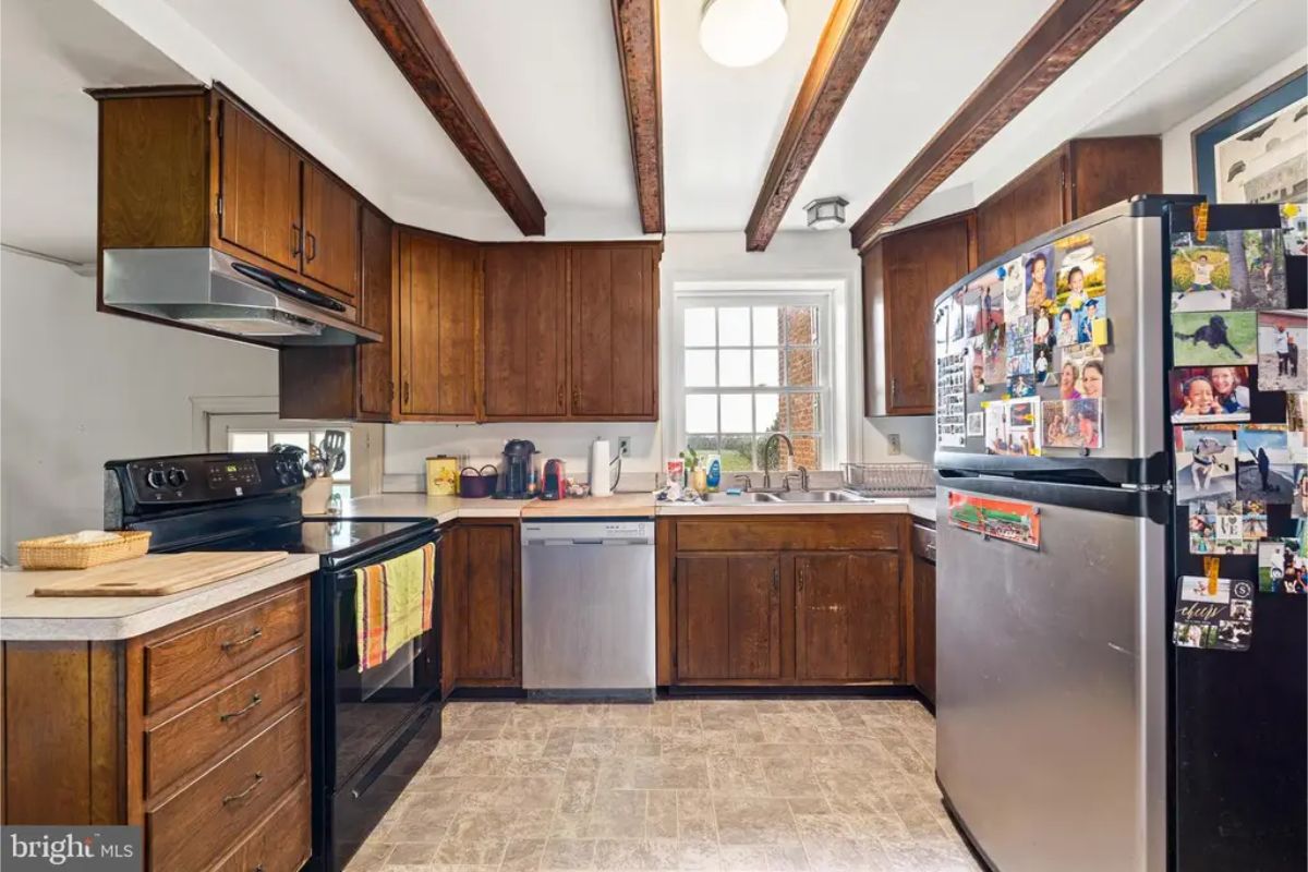 Dark wood cabinetry provides ample storage, complemented by stainless steel appliances and a modern countertop.