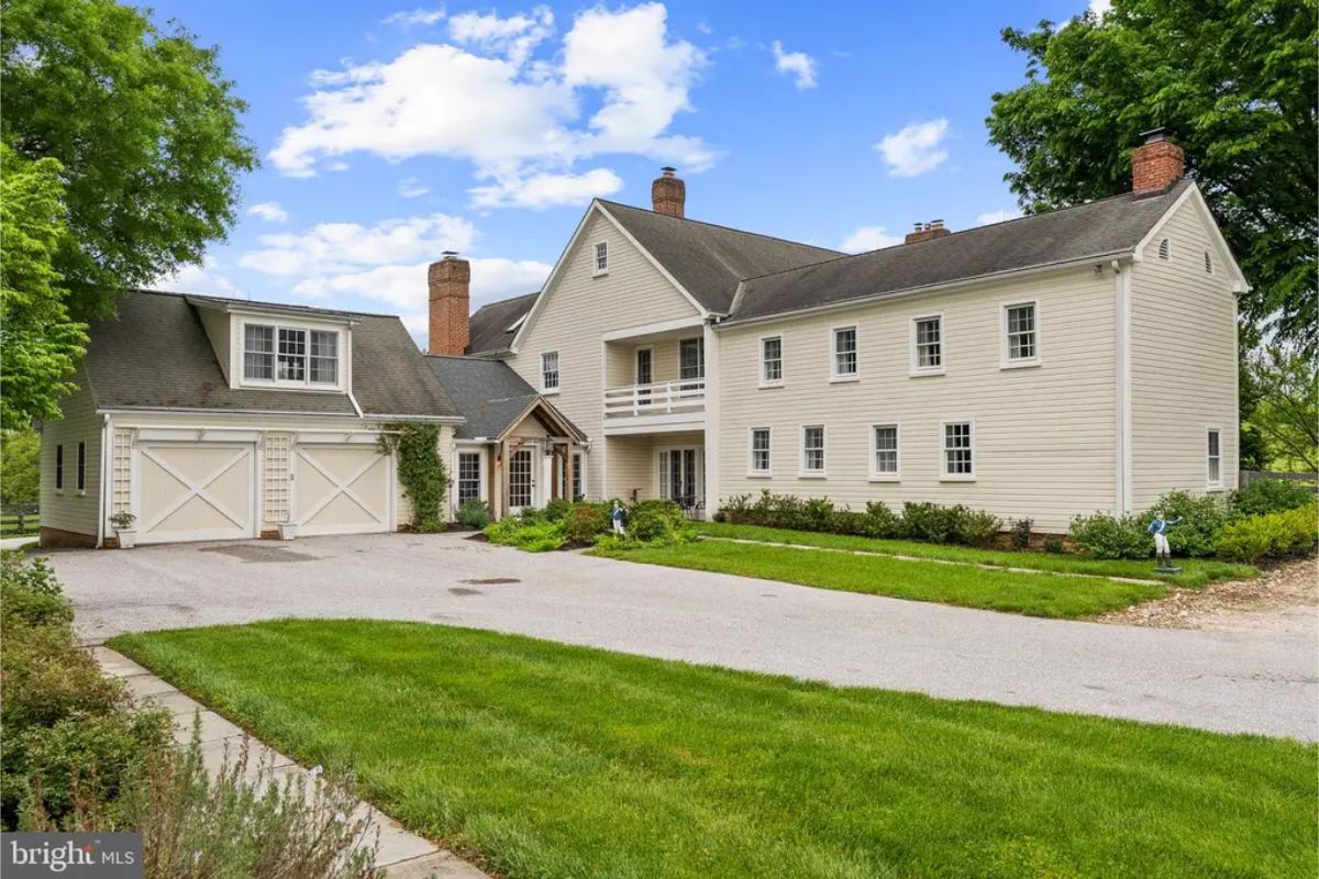 Charming two-story farmhouse with traditional architecture and attached two-car garage.