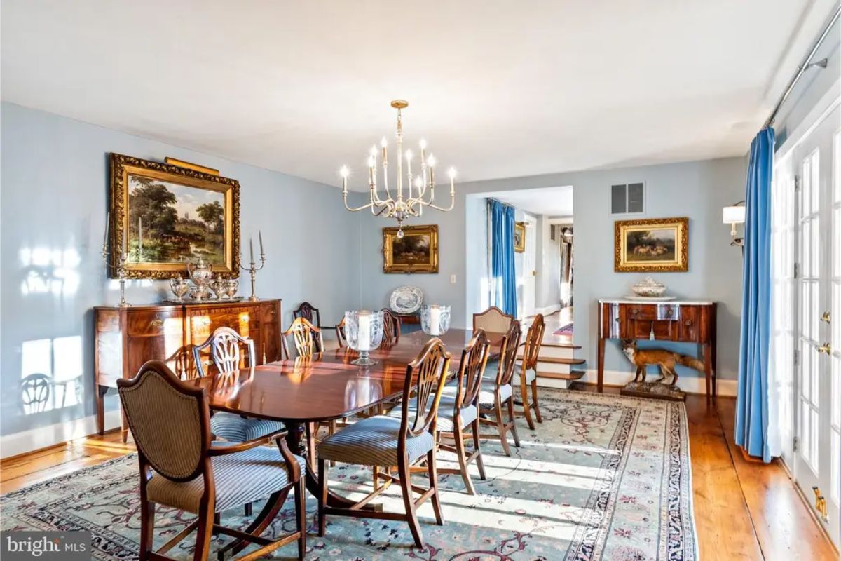 Spacious dining room with a long wooden table and matching chairs.