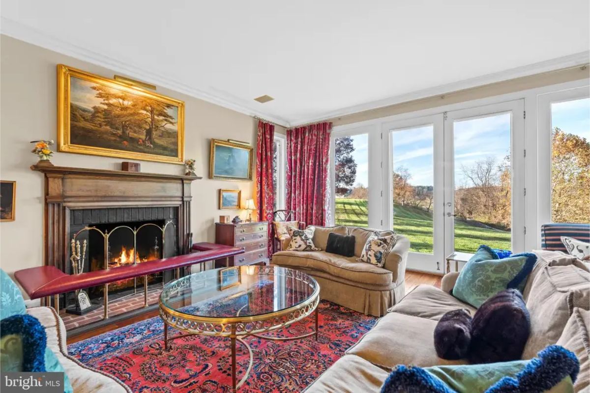 Living room with a traditional wood-paneled fireplace as a focal point.