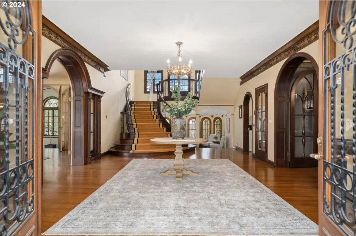 A round table placed at the center on a large area rug.