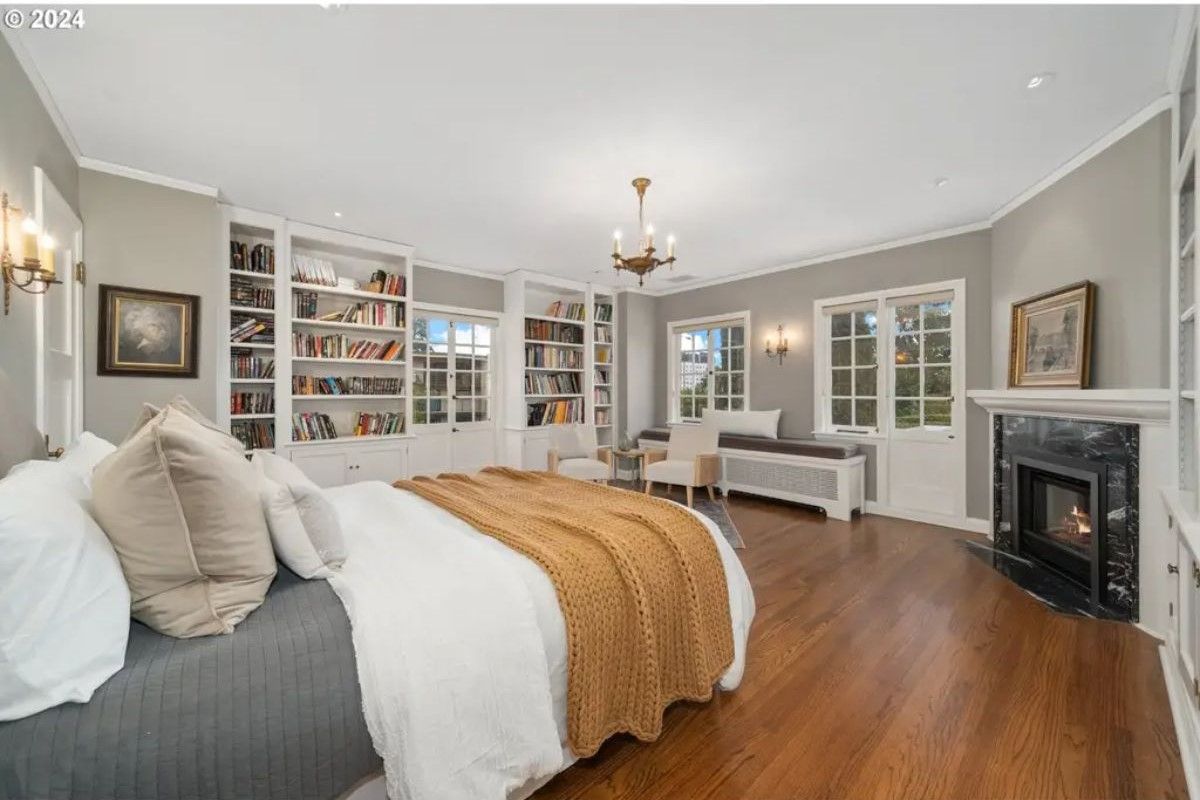 Bedroom has built-in bookshelves along one wall, filled with books and decorative items.