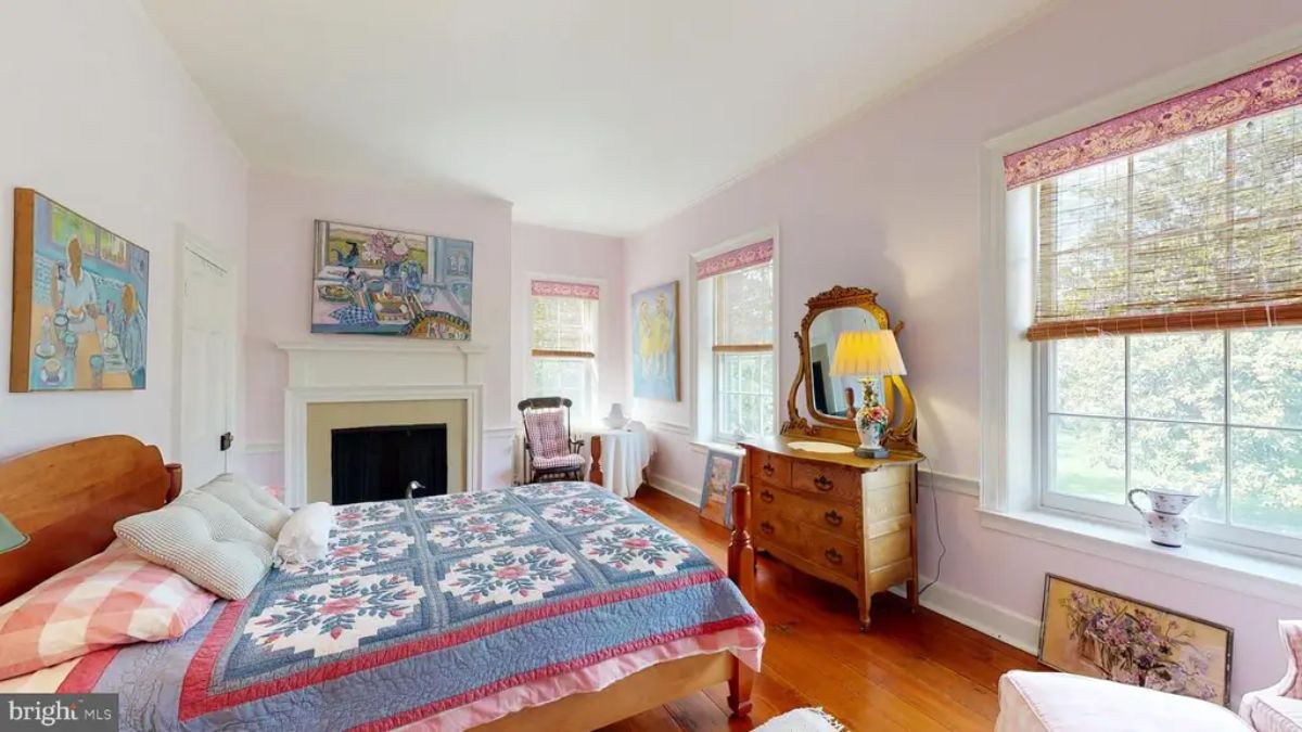 Cozy fireplace framed with a simple white mantel.