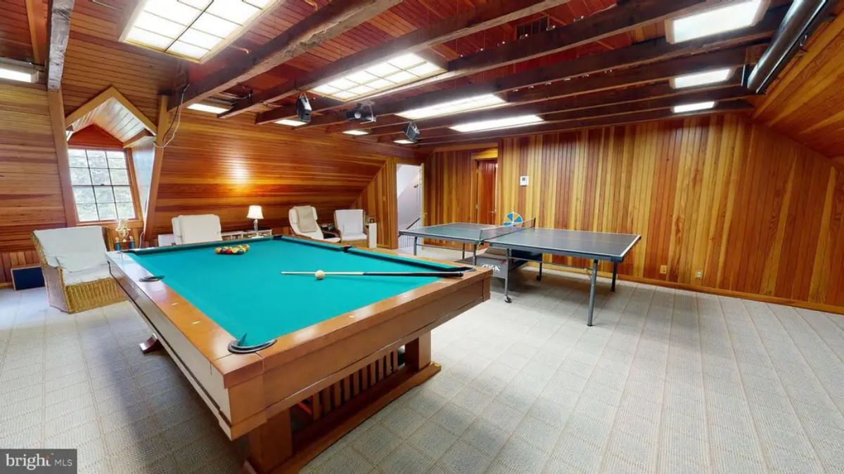 Recreation room offers a billiard table and ping pong setup for leisure activities.