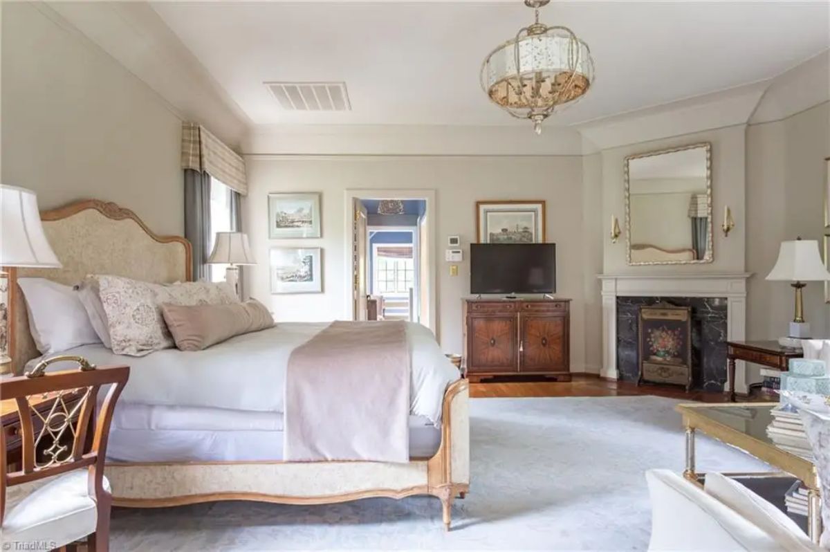 Bedroom is styled with a neutral palette, featuring an upholstered bed and coordinated bedding.