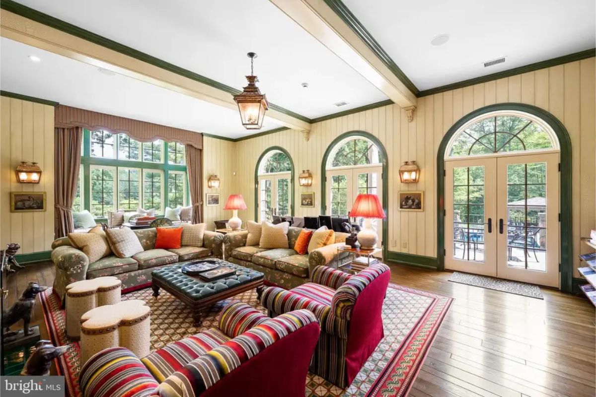 Large arched windows and doors allowing natural light and access to the outdoors.