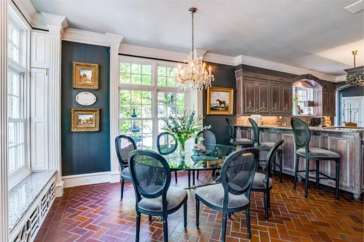 Dining space with a glass-top table and upholstered chairs.