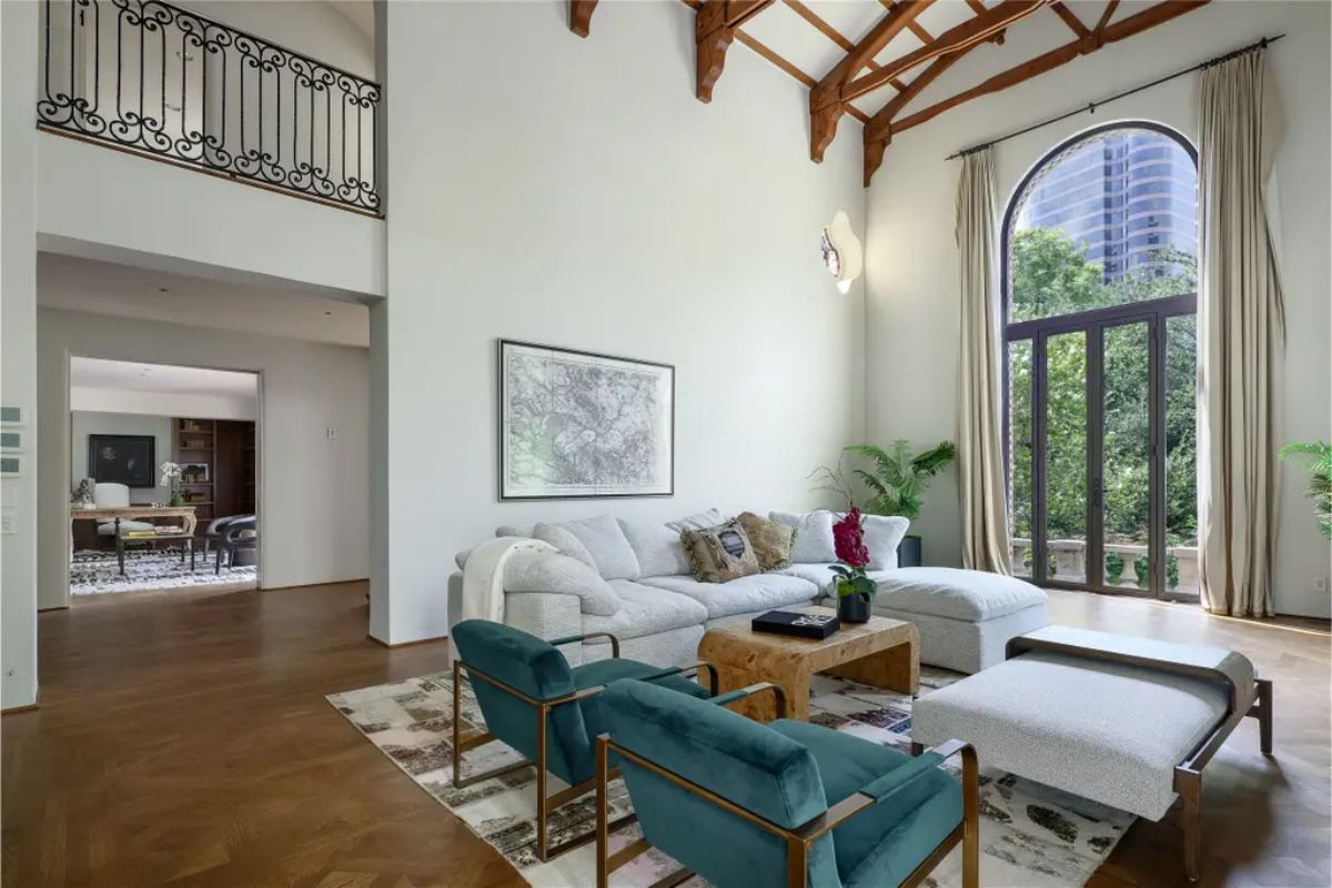 Living room with high, vaulted ceilings and exposed wooden beams.