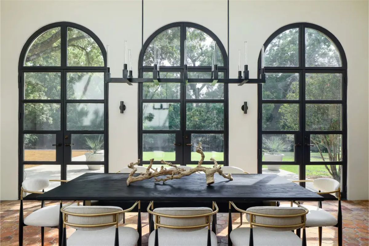 Arched floor-to-ceiling windows providing expansive views of the garden.