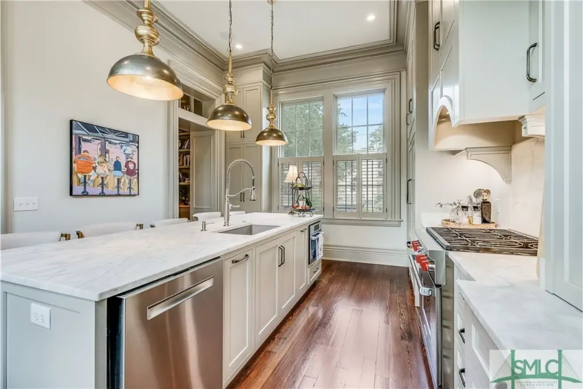 Streamlined kitchen design with light cabinetry and marble countertops.