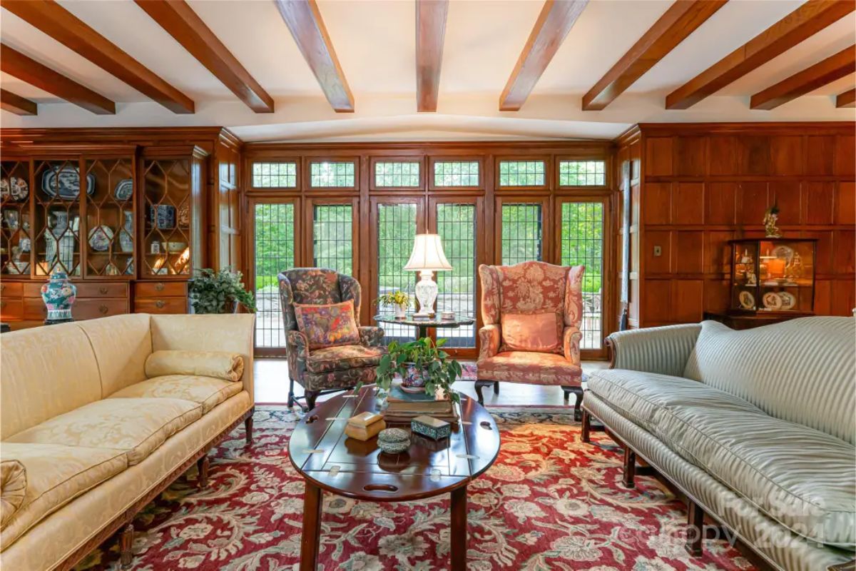 Extensive wood paneling and a ceiling with exposed beams, creating a warm atmosphere.