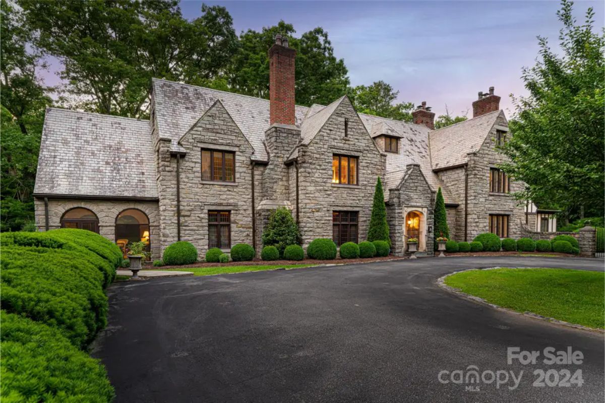 Set on over nine acres in Biltmore Forest, this 1924 Tudor estate, designed by architect Charles Parker, features an 11-bedroom, 10-bath layout across a 7,739-square-foot main home.