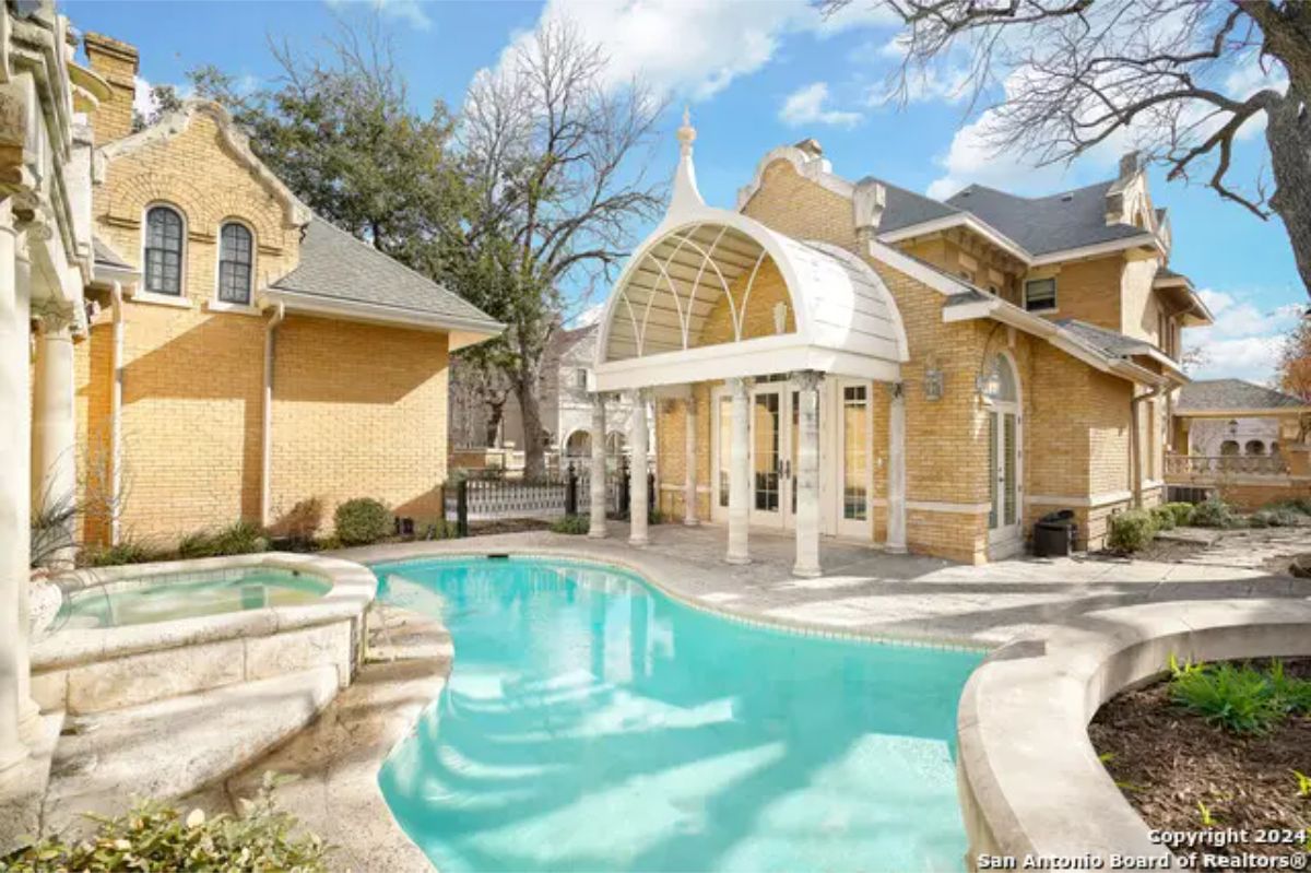 Outdoor pool area surrounded by natural stonework and landscaping.