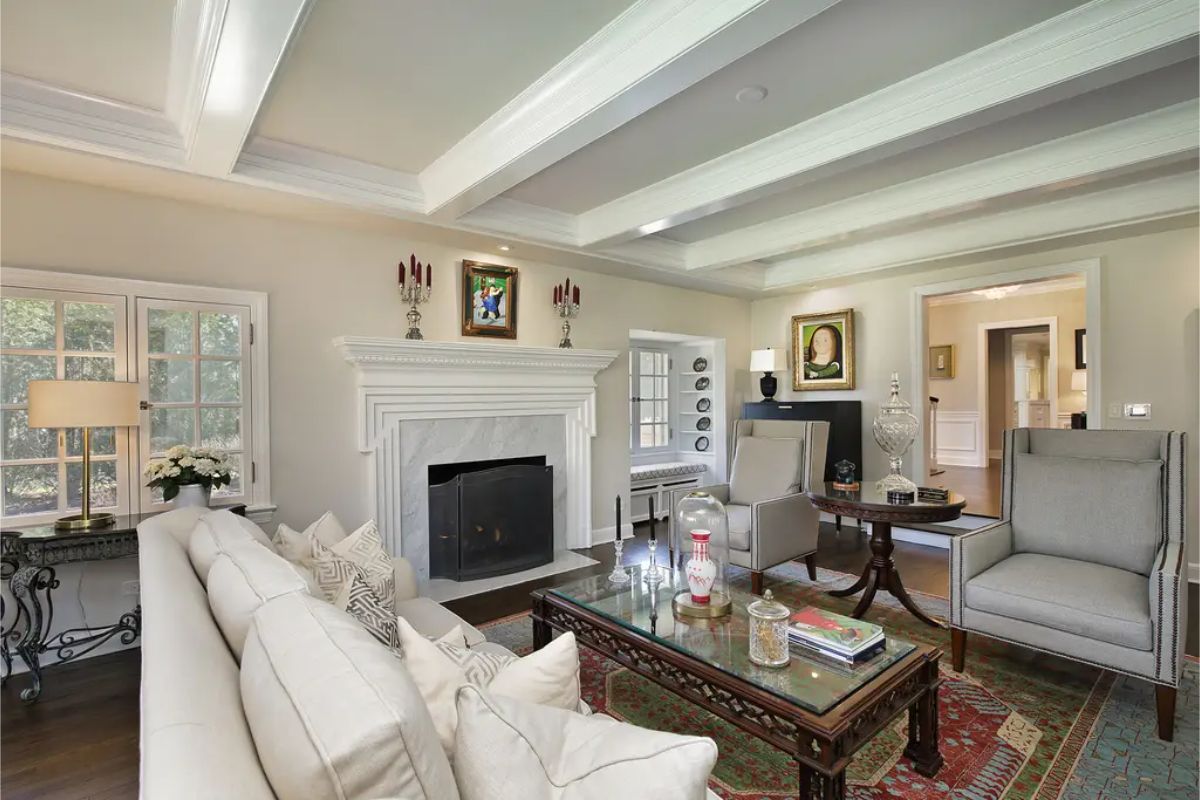 Coffered ceilings and recessed lighting add depth and dimension to the room.