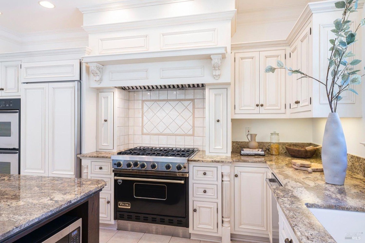 Gourmet kitchen with a professional-grade Viking range, custom cabinetry, and granite countertops.