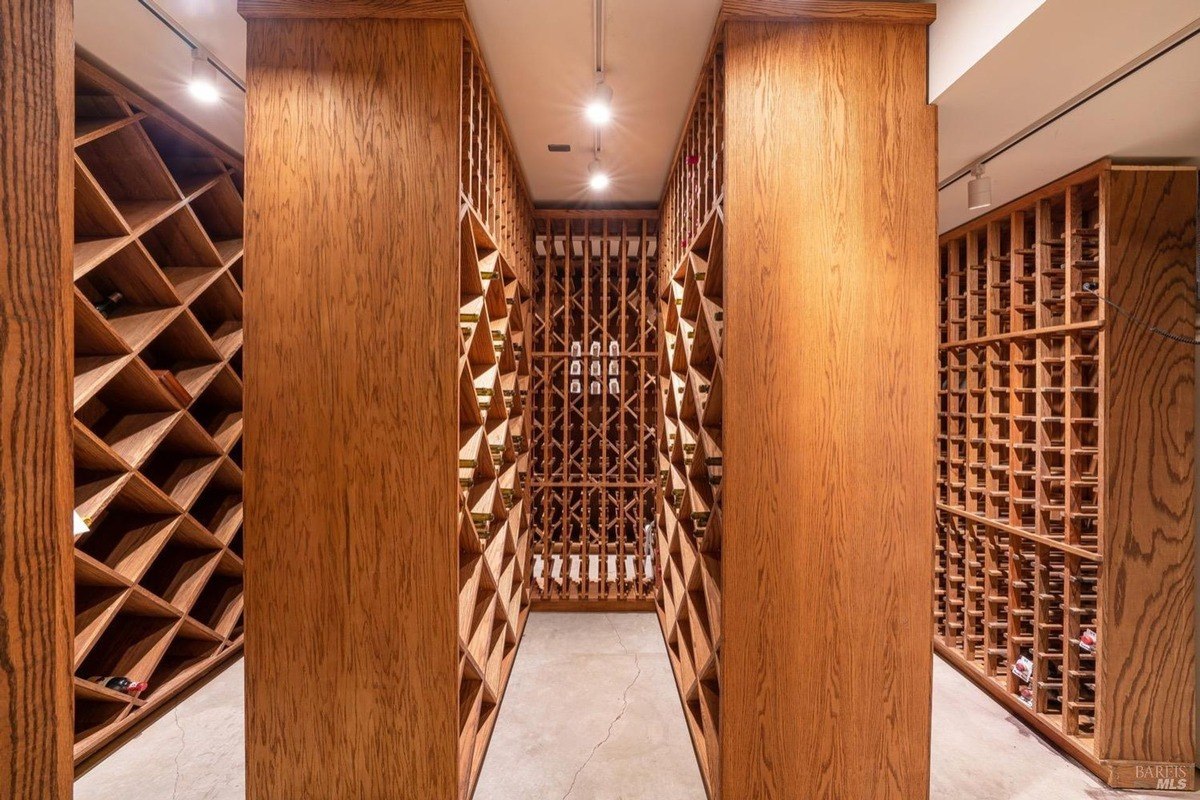 Wine cellar with custom wood racks, perfect for storing and displaying a vast wine collection.