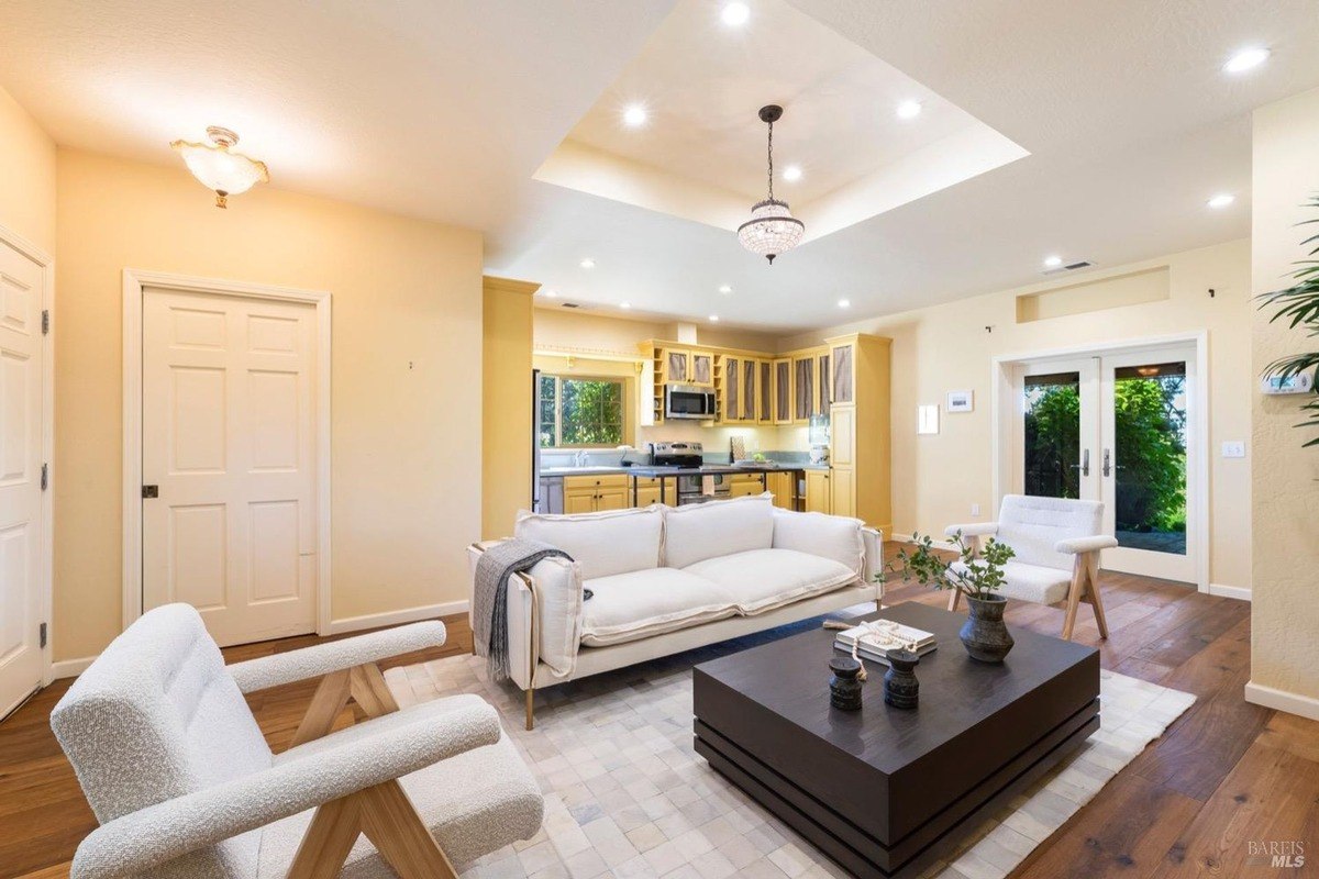 Bright living room with a comfortable sofa, armchairs, and a coffee table, creating a cozy space