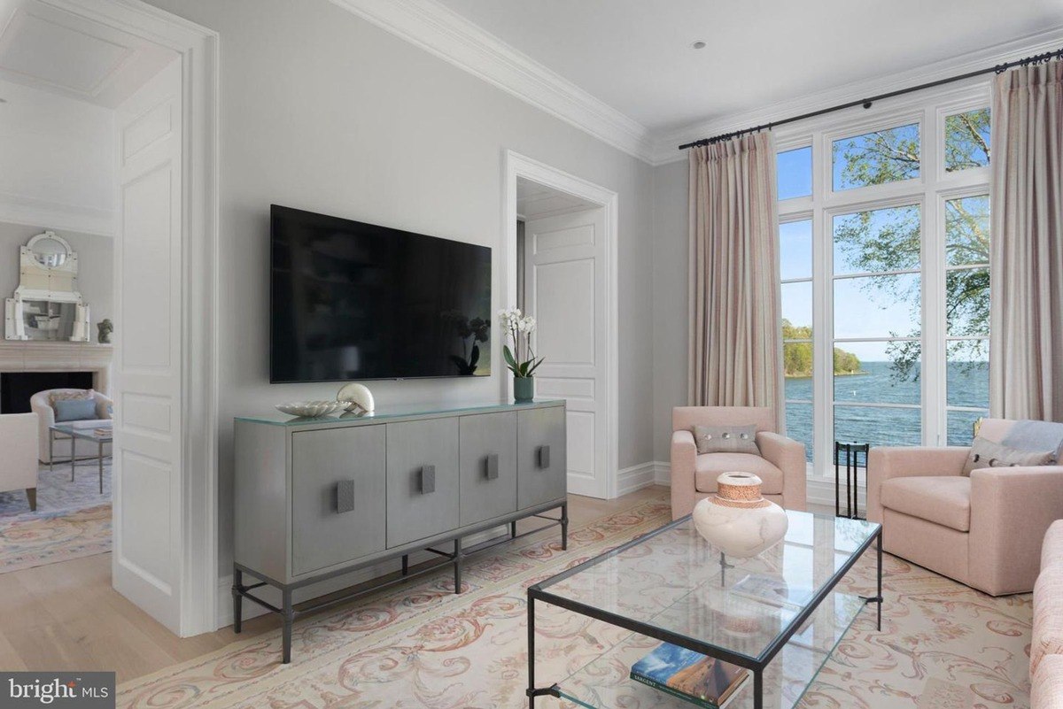 Relaxing room with water views, featuring a large flat-screen TV, and comfortable seating.