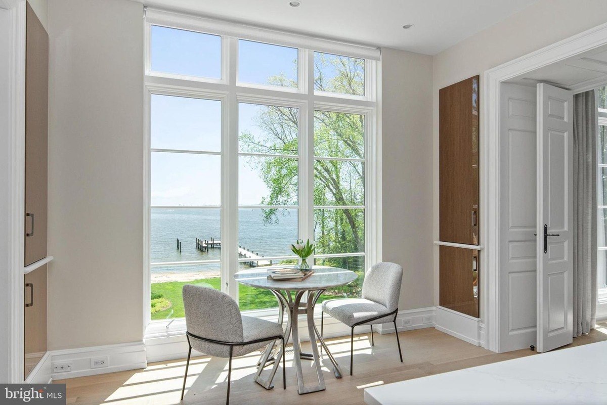 Breakfast nook with water views, featuring a small round table and two chairs.